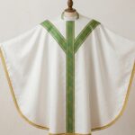 Children's white Catholic chasuble with green decorative bands and gold trim displayed on a mannequin, suitable for kids' Mass and liturgical services.